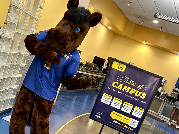SAU mascot next to a Taste of Campus sign